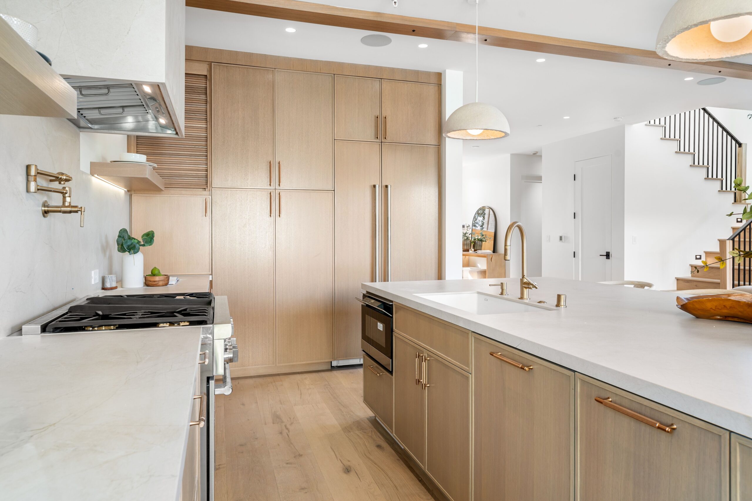 Modern kitchen with wooden cabinets and marble countertops. Windsor Plywood Calgary Bowridge - Your Local Building Supply Store